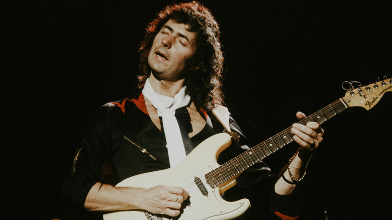 Ritchie Blackmore plays guitar on stage