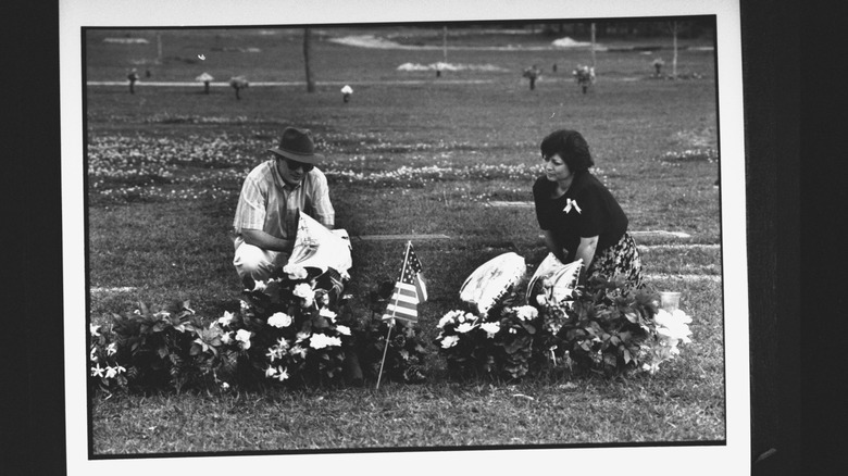 family members visiting the graves of yogurt shop murder victims