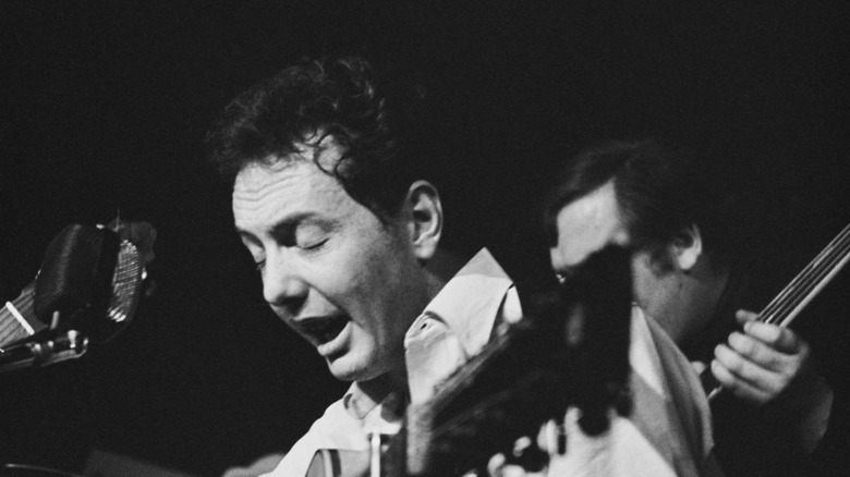 Fred Neil singing and playing guitar onstage