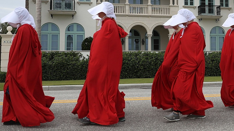 Female protesters dressed as handmaids