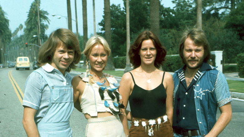 Young ABBA members posing in the street in the 1970s