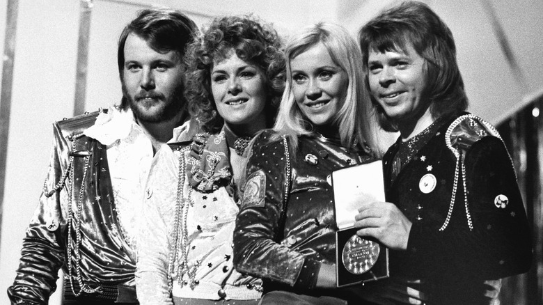 ABBA onstage with medal in the 1970s in black and white