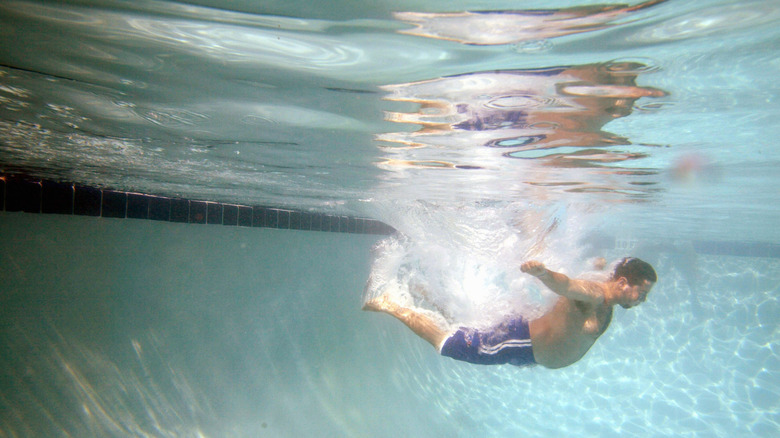 Guy belly flopping into pool
