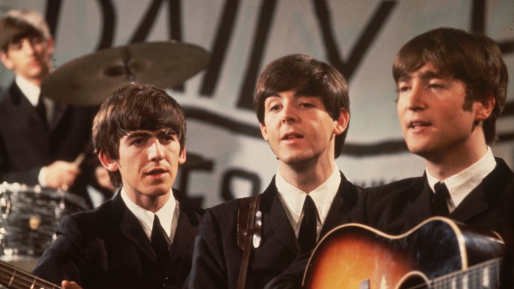George, Paul, and John with poor Ringo in the background