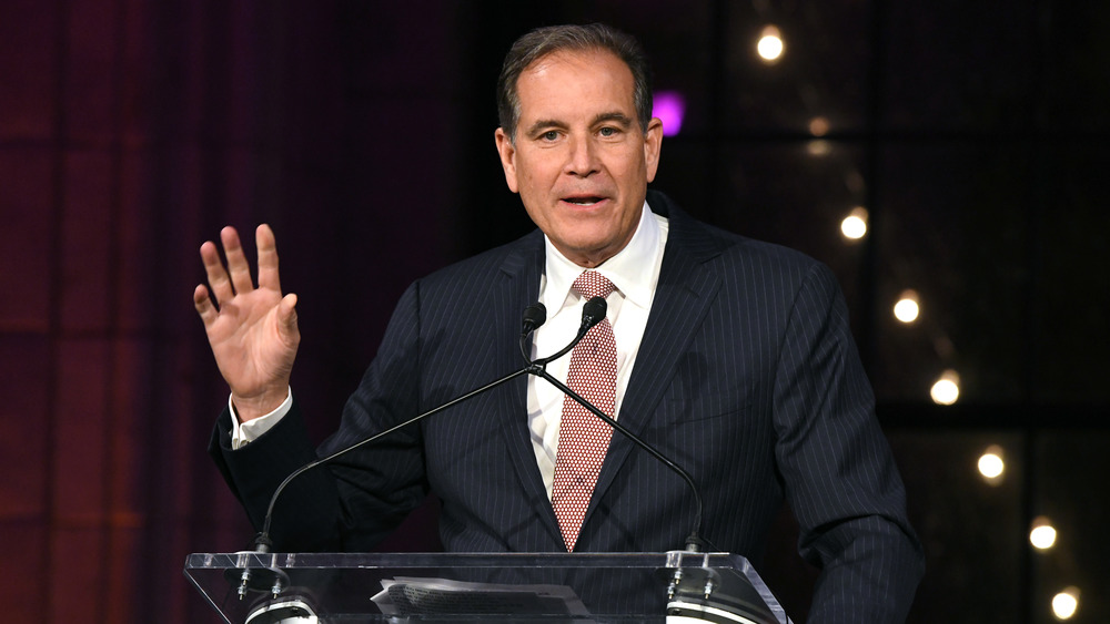 Jim Nantz speaking at a lectern in 2018