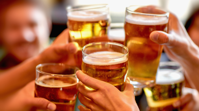 people raising glasses of beer