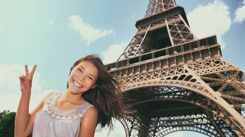 Asian tourist in front of the Eiffel Tower