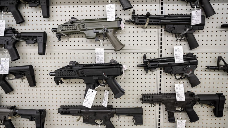 guns on a wall at a store