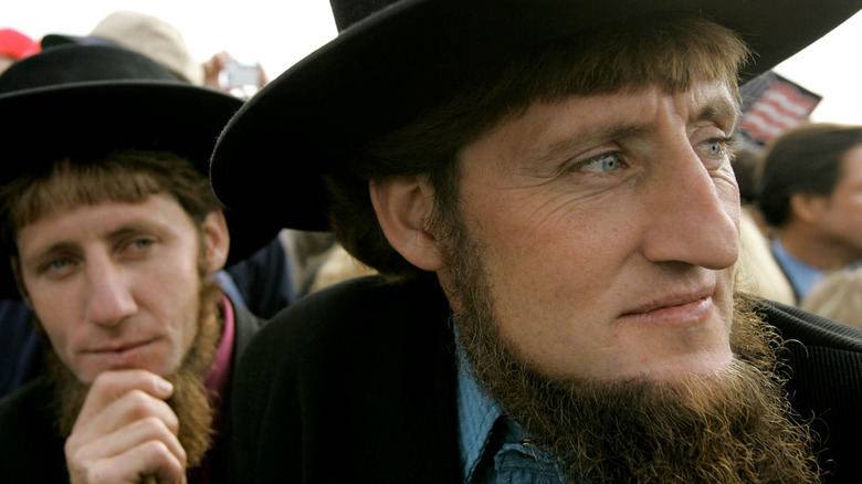 Amish men listening to George W. Bush