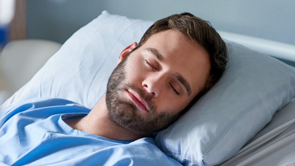 sleeping man in hospital bed