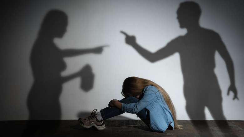angry parents arguing over a scared child