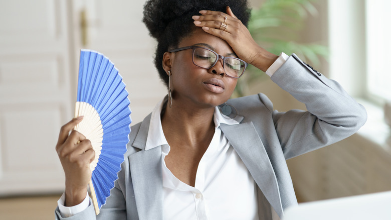 woman getting too hot while working