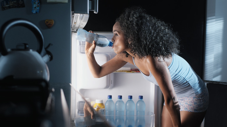 woman getting a drink in the middle of the night