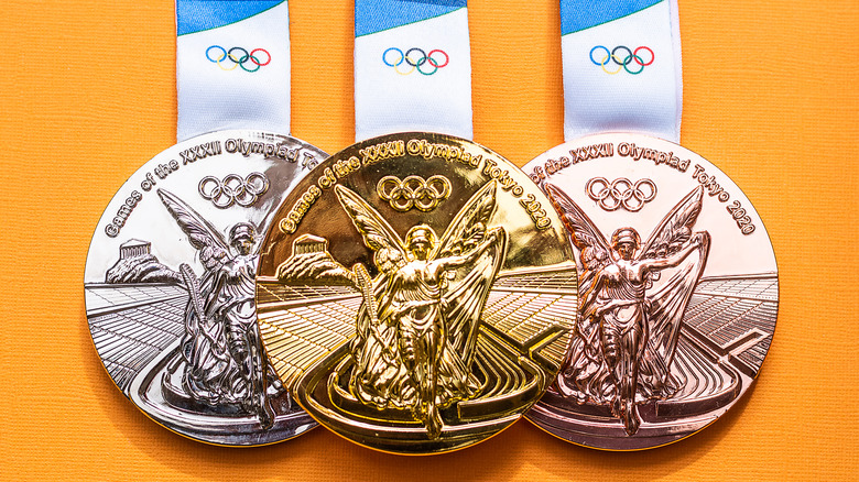 Tokyo Olympic medals against a yellow background 