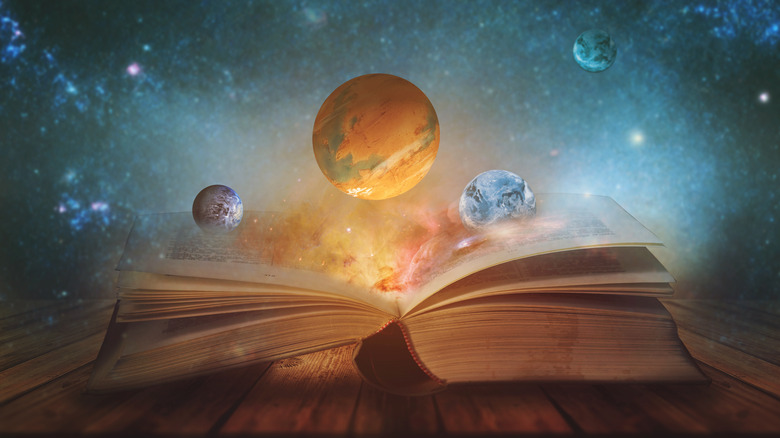 Bible with sky and planets