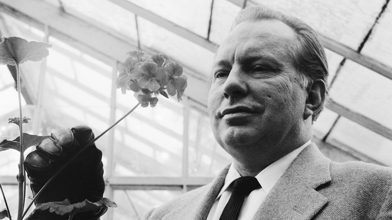 L. Ron Hubbard examining flower