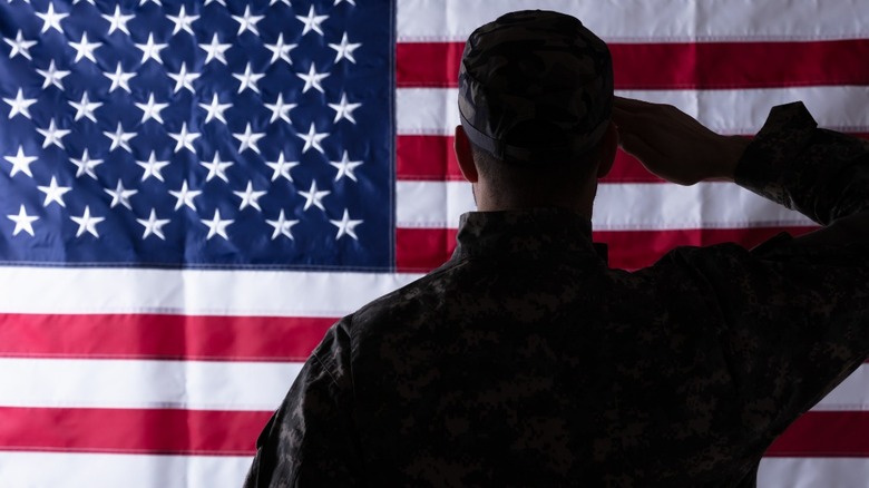 Solider salutes American flag