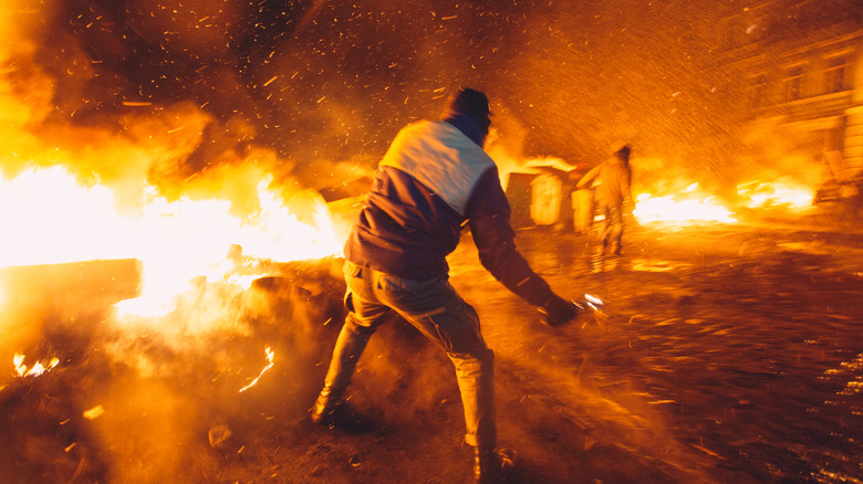 Protester throwing Molotov cocktail