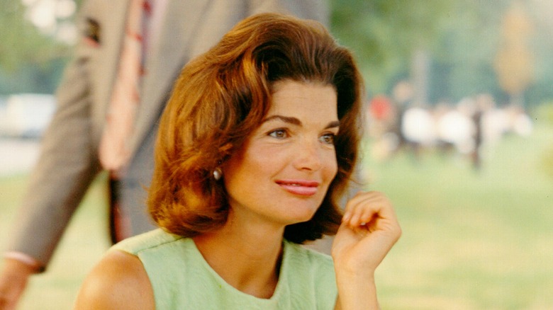 Jackie Kennedy smiling in green dress