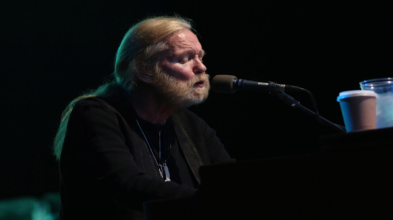 Gregg Allman singing at a piano