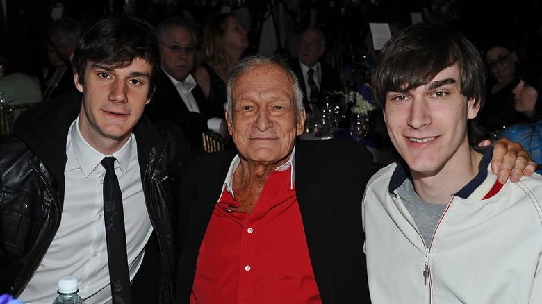 Hugh Hefner posing with sons
