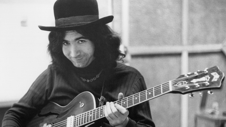 jerry garcia holding a guitar