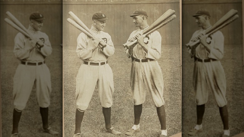 Shoeless Joe Jackson and Ty Cobb holding multiple baseball bats