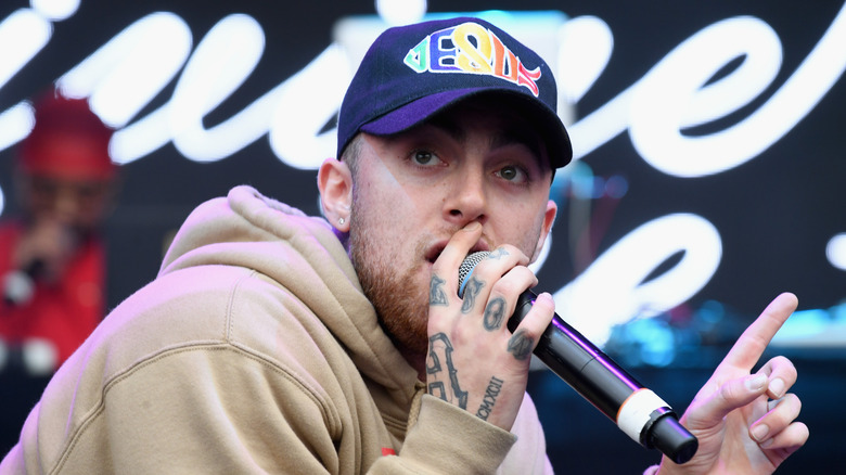 Mac Miller performing in a hat
