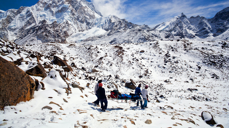 sherpas evacuate an injured climber