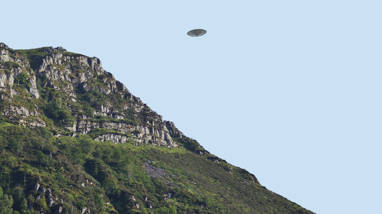 UFO flying over cliffs