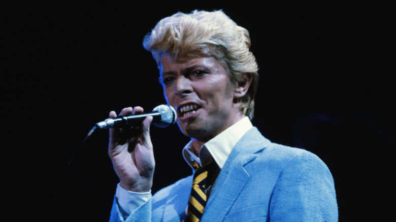 David Bowie singing into a microphone during the Let's Dance tour