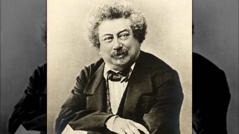 Alexandre Dumas sitting and smiling
