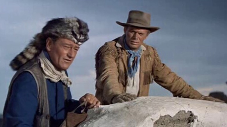 John Wayne dressed as Davey Crockett with furry hat in 'The Alamo'