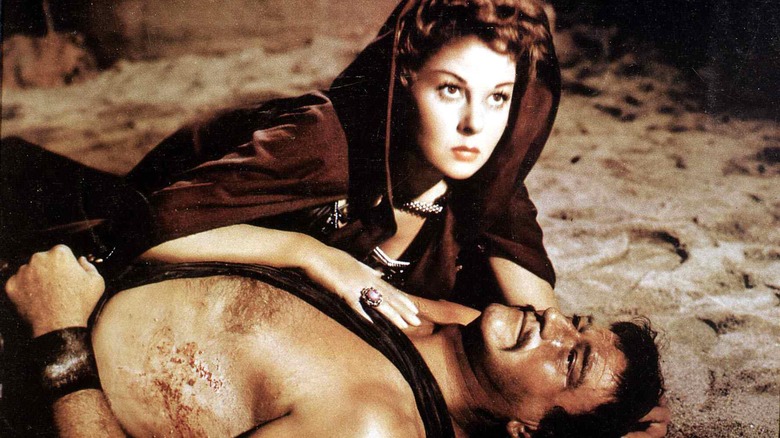 john wayne and susan hayward laying on floor in the conqueror