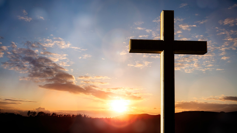 crucifix against sunset sky