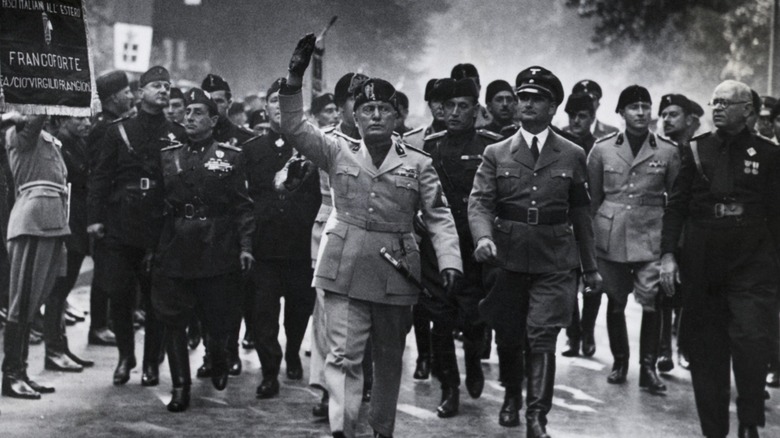 Benito Mussolini marching