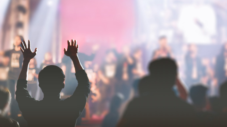 Crowd with hands up looking at stage