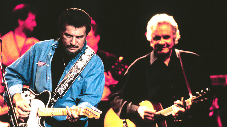 Waylon Jennings and Johnny Cash playing guitars