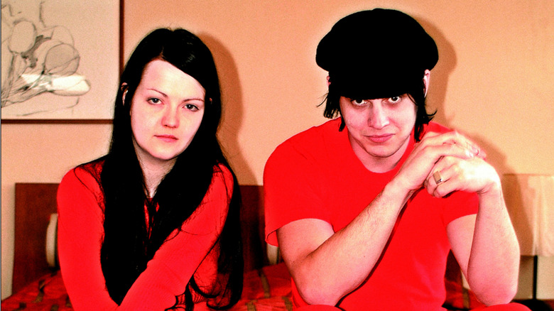 Meg White and Jack White sitting in motel room staring at camera