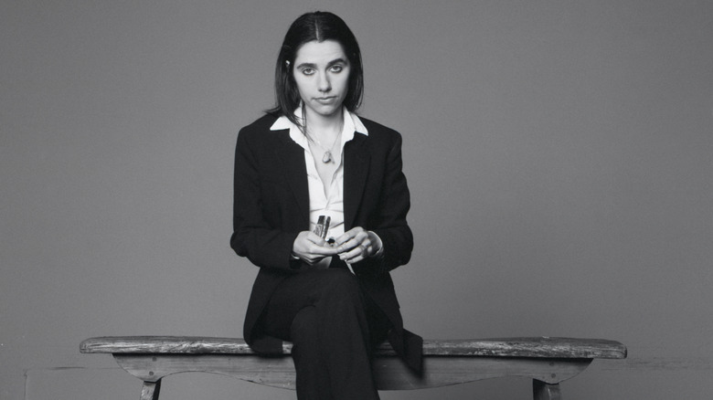 PJ Harvey sitting and staring at camera