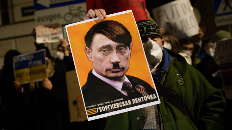 A protest sign comparing Putin to Hitler