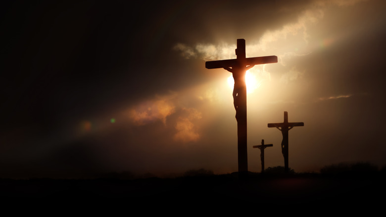 Crucifixion silhouette with dramatic lighting
