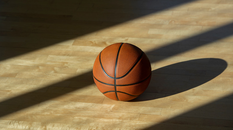 A basketball on floor of court