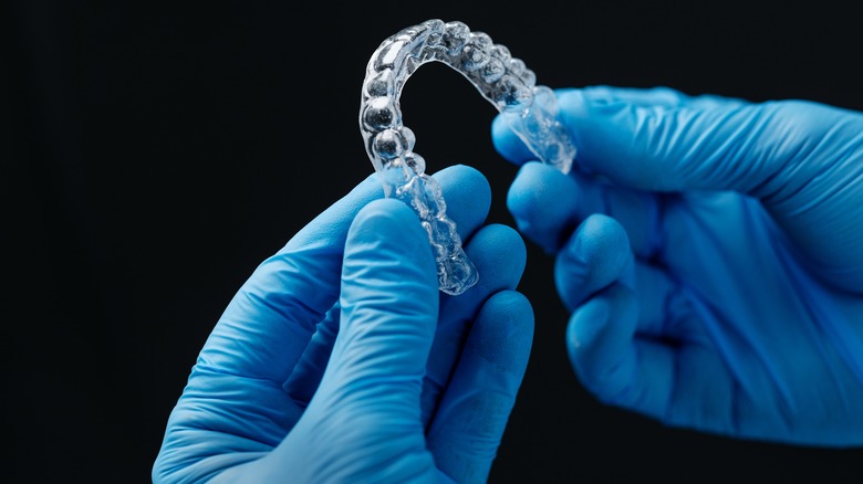 blue gloves hands tooth impression