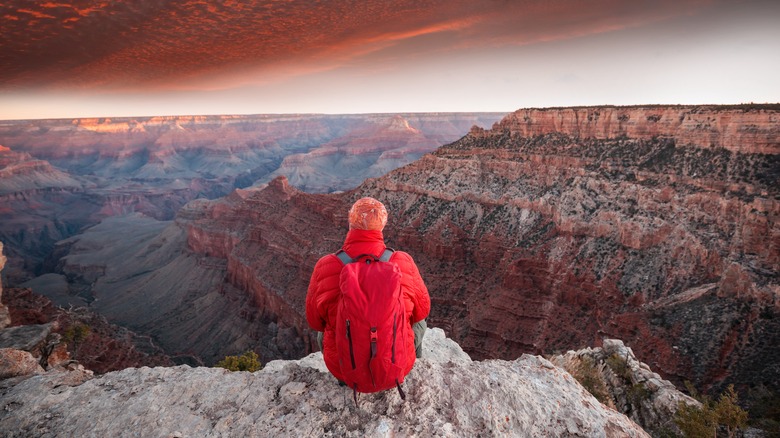 sitting on cliff at Grand Canyon