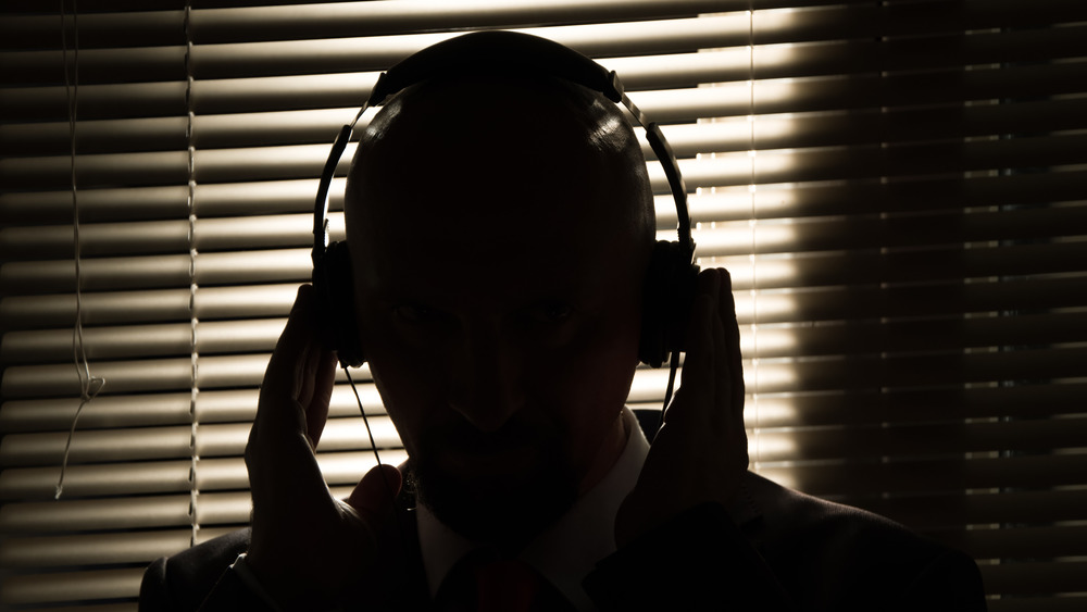 The silhouette of a secret agent gives directives into a headset