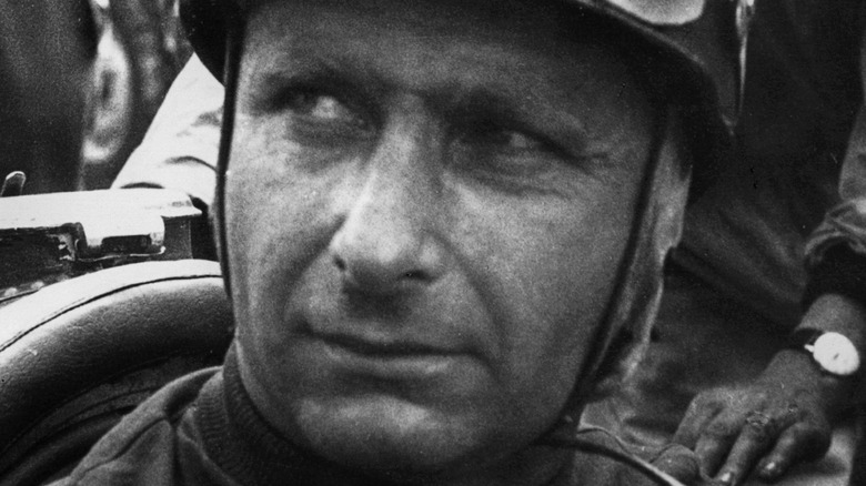 Juan Manuel Fangio looking to side