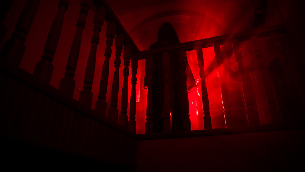 Ghostly figure staring down from railing