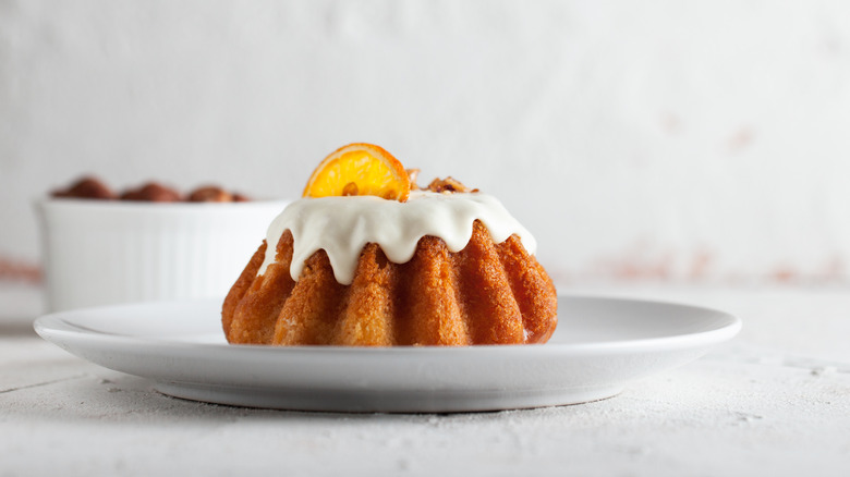 An iced rum cake on a plate on a table
