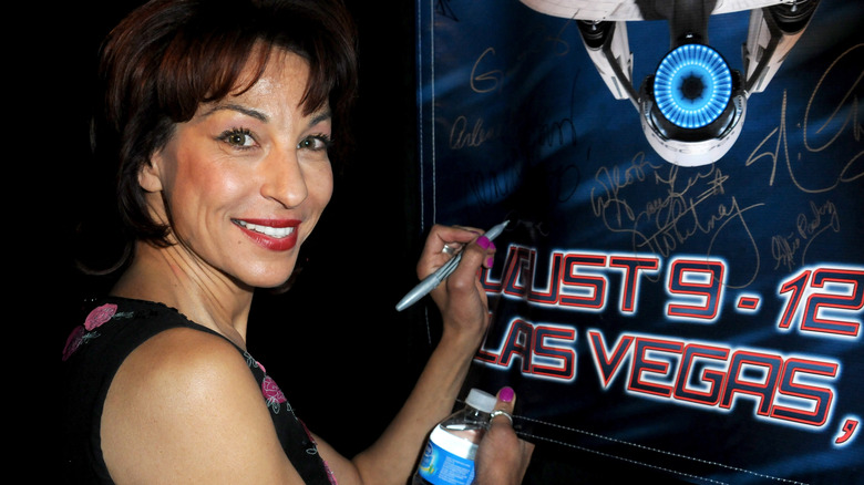 Lycia Naff signing a poster, 2012